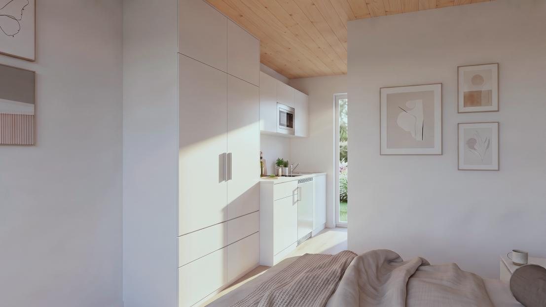 Einbauschrank und Bettbereich in einem Studioapartment